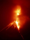 Lava Explodes from the Mount Mayon Volcano Amid Clouds of Gas and Ash