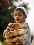 A Boy Carries Rusk as He Assists Others to Send a Consignment of Relief Supplies to Uri