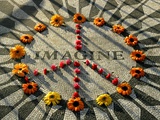 A Makeshift Peace Sign of Flowers Lies on Top John Lennon's Strawberry Fields Memorial