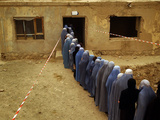 Afghan Women Wearing Burqa Line up to Vote at a Polling Station