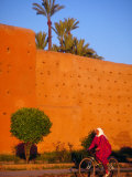 Veiled Woman Bicycling Below Red City Walls  Marrakech  Morocco