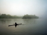 A Lone Rower Slowly Maneuvers His Craft Down the Schuykill River Through a Thick Fog