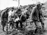 A US Navy Corpsman Administers Blood Plasma to a Wounded Marine