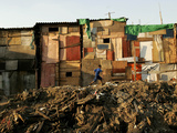 A Child Runs by a Row of Shacks in Novo Mundo Shantytown  Sao Paulo  Brazil