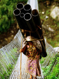 A Women Carrying a Heavy Load Across a Bridge  Kalopani  Annapurna Circuit  Nepal