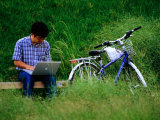 Man Using Laptop Computer Beside His Bicycle Near Kamogawa River  Kyoto  Japan