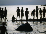 Playing Children Silhouetted Against Water  Malala  Papua New Guinea