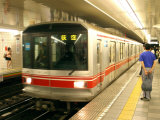 People Waiting to Board Subway Train  Tokyo  Japan
