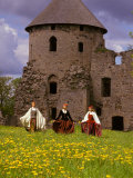 Traditionally Dressed Girls Walk Through Dandelions  Cesis castle  Latvia