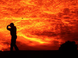 Golfer and Sunset with Dramatic Clouds