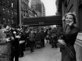 Actress Grace Kelly in Casual Pose with Armful of Roses Standing on Sidewalk During Shopping Trip