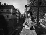 French Writer Albert Camus Smoking Cigarette on Balcony Outside His Publishing Firm Office
