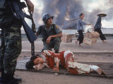 SVietnamese Soldier Crouched Next to Bleeding Woman While Awaiting Medical Aid
