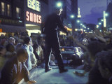Presidential Candidate Robert Kennedy Standing on Back of Convertible Car While Campaigning