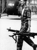 Yankee Papa 13 Helicopter Crew Chief James Farley Carrying a Pair of M-60 Machine Guns