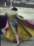 Bullfighter Manuel Benitez  Known as "El Cordobes " Sweeping His Cape Aside a Charging Bull