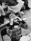 Hollywood Child Timmy Garry at Children's party Dressed in Cowboy Outfit eating a Hamburger