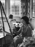 Jackie Kennedy  Wife of Sen  Painting on an easel as Daughter Caroline Paints on Table at Home