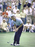 Golfer Arnold Palmer Lining Up Putt as Spectators Look on at Event
