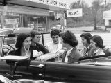 Teenage Girls Enjoying Milkshakes at Drive in Restaurant