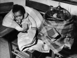 African American Baby Next to Cage of Canaries in a Shelter at School During Severe Flooding