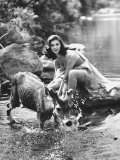 Actress Pier Angeli  Clad in Strapless Chiffon Party Dress Sitting on a Rock in a Pond