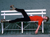 Actress Melissa Gilbert Reclining on a Bench While Wearing Roller Skates