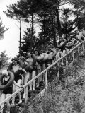 Line of Fun Seekers with Inner Tubes Descending Staircase to Pier for Floating Party on Apple River