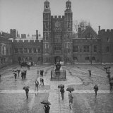 Eton Students in Traditional Tails and Striped Trousers  with Umbrellas  Standing in the Rain