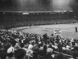 Crowd of People Holding Up Signs and Watching Dodger Cubs Game from Stands at Wrigley Field