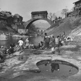 Yangtze River Essay: Women Washing Laundry on Shores of Yangtze River Near Ancient Arched Bridge