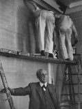 Architect Frank Lloyd Wright Posing for a Picture Beneath Workmen on Scaffold