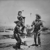 Actor Kirk Douglas in Western Outfit Showing His 2 Sons Some Fancy Gun Handling at Dude Ranch