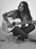 Folk Singer Joan Baez Strumming Her Guitar on the Beach Near Her Home