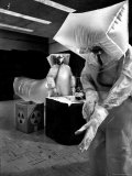 Technicians in Plastic Protective Suits and Face Masks Repair Pressure Valve at Atomic Energy Plant