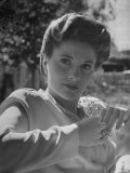 Actress Joan Fontaine Wearing Film Makeup and a Pompadour Hairdo  Relaxing in Garden at Home