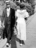 African American Sporting His Sunday Finery Glancing at Frilly Frocked Girl Passing Him on Street