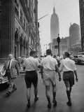 Three Young Businessmen Wearing Bermuda Shorts as They Walk Along Fifth Ave During Lunchtime