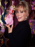 Actress Barbara Eden Holding Up Jeannie Doll