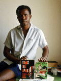 Nigerian Author Chinua Achebe Holding Two Editions of His Book Things Fall Apart