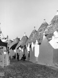 Row of Trulli Homes Made from Limestone Boulders and Feature Conical or Domed Roofs