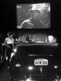 Female Car-Hop Taking Order from Couple in Convertible Car During Movie at Rancho Drive in Theater