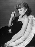 Dancer/Actress Lucille Ball in Strapless Black Lace Evening Dress  Holding Lit Cigarette on Couch