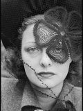 Woman Wearing a Veil with Flower Pattern Placed Strategically over Her Left Eye