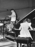 Lorin Maazel Conducting an Orchestra During Rehearsal as Young Sondra Bianca Plays the Piano