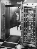Bank Employee Selecting a Safety Deposit Box for a Customer Inside Vault Area