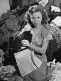 Actress Shirley Temple  Gathering Her Unwanted Clothes Together to Donate to a Clothing Drive