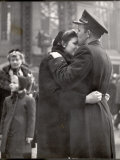 Soldier Tenderly Kissing His Girlfriend's Forehead as She Embraces Him While Saying Goodbye