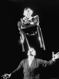3 Year Old Teetering Tot on Chair Are Kept in Equilibrium by Robert Dotzauer's Muscular Chin