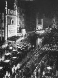 People Waiting in Front of the Brightly Lighted Empire Theatre for the Royal Film Performance